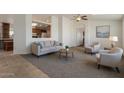 Comfortable living room with neutral tones, plush seating, and seamless flow to the kitchen at 2929 E Sequoia Dr, Phoenix, AZ 85050
