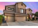 Inviting two-story home with a three car garage and desert landscaping at 6971 W El Cortez Pl, Peoria, AZ 85383