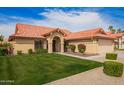 Charming single-story home with a well-manicured lawn, tile roof, and a welcoming front entry at 7626 W Mcrae Way, Glendale, AZ 85308