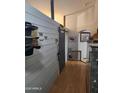 Interior entryway with hats, cowboy themed art, and hard wood flooring at 11590 W Cocopah St, Avondale, AZ 85323
