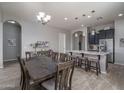 Open dining area with a large table and chairs, seamlessly connected to the kitchen island at 12158 S 184Th Ave, Goodyear, AZ 85338