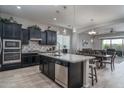 Spacious kitchen with stainless steel appliances, granite countertops, and an adjacent dining area at 12158 S 184Th Ave, Goodyear, AZ 85338