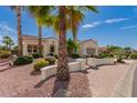 Beautiful desert home featuring lush landscaping and palm trees in a serene neighborhood at 12835 W Chapala Ct, Sun City West, AZ 85375