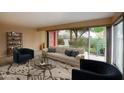 Bright living room with large windows, comfortable seating, and stylish decor at 130 E Coronado Rd # 16, Phoenix, AZ 85004