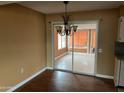 Dining room with chandelier and sliding door leading to the lanai at 16805 N 110Th Ave, Sun City, AZ 85351