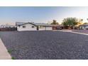 Inviting single-story home with a well-manicured exterior, a gravel yard and a driveway at 1718 S Marilyn Ann Dr, Tempe, AZ 85281