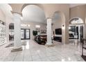 Expansive living room with tiled floors, decorative columns, and an open layout at 2226 E Beachcomber Dr, Gilbert, AZ 85234