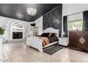 Spacious main bedroom features a striking black ceiling, chandelier, and ensuite bathroom at 2226 E Beachcomber Dr, Gilbert, AZ 85234