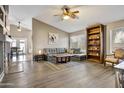 Bright living room boasts hardwood floors, a ceiling fan, and large windows for natural light at 2727 S Sawyer Cir, Mesa, AZ 85209
