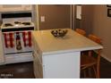 Kitchen island offering additional countertop space and seating for casual dining at 303 S Recker Rd # 218, Mesa, AZ 85206