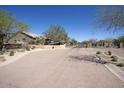 Rolling Hills gated entrance with desert landscaping, brick walls, and manicured shrubbery at 3564 N Tuscany --, Mesa, AZ 85207