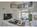 Lofted living room showcasing modern railing, backyard views, and open floor plan at 3564 N Tuscany --, Mesa, AZ 85207