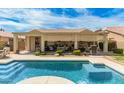 Stunning backyard features a sparkling pool, covered patio, and lush landscaping at 3871 S Marion Way, Chandler, AZ 85286