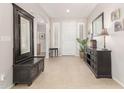 Spacious entryway boasting neutral colored tile and large dark wood furnishings at 3871 S Marion Way, Chandler, AZ 85286