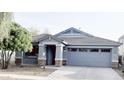 Charming single-story home with a well-manicured yard, a two-car garage, and stone accents at 4176 E Bonanza Rd, Gilbert, AZ 85297