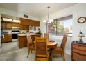 Cozy dining area with natural lighting, wood table, four chairs and wood accents at 4303 E Cactus S Rd # 329, Phoenix, AZ 85032