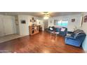 Spacious living room with wood floors and large windows offering natural light at 444 W Fabens Ln, Gilbert, AZ 85233