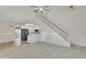 Open-concept floor plan with stairs, living room and kitchen area at 500 N Roosevelt Ave # 61, Chandler, AZ 85226