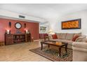 Bright living room showcasing hardwood floors, a decorative rug, and comfortable seating at 5741 W Purdue Cir, Glendale, AZ 85302