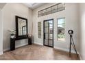 Bright, elegant foyer with soaring ceilings, herringbone floors, statement mirror and stylish lighting at 6209 E Bramble Berry Ln, Cave Creek, AZ 85331