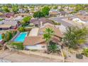Aerial view of a backyard with a fenced pool, palm trees, and a covered patio, creating a private oasis at 6608 S Willow Dr, Tempe, AZ 85283