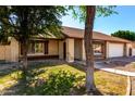 Charming brick home with mature trees and a well-maintained front yard at 6608 S Willow Dr, Tempe, AZ 85283