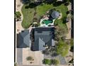 Stunning aerial view of home with pool, lush landscaping, gazebo, driveway and solar panels on roof at 8755 E Gary Rd, Scottsdale, AZ 85260