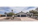 Charming single-story home featuring a three car garage and desert landscaping at 8755 E Gary Rd, Scottsdale, AZ 85260