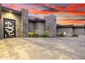 Modern home featuring stone accents, desert landscaping, and a decorative front door at 9127 N Fireridge Trl, Fountain Hills, AZ 85268
