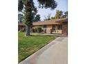 Charming single-story home featuring well-kept lawn and covered entryway, creating a welcoming curb appeal at 15462 N Lakeforest Dr, Sun City, AZ 85351