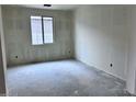 An unfinished bedroom features natural light, a modern window, and electrical wiring ready for customization at 32155 N Lone Rancher Way, San Tan Valley, AZ 85140