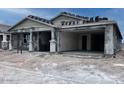 New construction home featuring a covered front porch with stately columns and an attached two-car garage at 32155 N Lone Rancher Way, San Tan Valley, AZ 85140