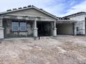 New construction home featuring a covered front porch with stately columns and an attached two-car garage at 32155 N Lone Rancher Way, San Tan Valley, AZ 85140