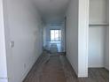 Hallway of new home that leads to a sliding glass door, tile floor, and a closet at 32155 N Lone Rancher Way, San Tan Valley, AZ 85140