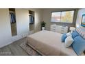 Well-lit bedroom featuring a large window, closet, and modern decor for a comfortable living space at 4734 N 61St Ave, Phoenix, AZ 85033