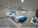 Tastefully decorated primary bedroom with a ceiling fan, stylish decor, and an ensuite bathroom at 4734 N 61St Ave, Phoenix, AZ 85033