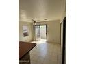 Bright dining area with a ceiling fan and sliding glass door leading to the outside at 4820 N 89Th Ave # 45, Phoenix, AZ 85037