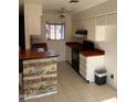 Functional kitchen with white cabinetry and neutral tile flooring for easy upkeep at 4820 N 89Th Ave # 45, Phoenix, AZ 85037