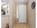 Bright entryway featuring neutral tones, tile flooring, and a decorative front door at 1172 S 229Th Dr, Buckeye, AZ 85326