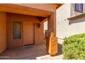 Close-up of the front door entrance showing the exterior home materials, landscaping and lighting at 1384 E Press Rd, San Tan Valley, AZ 85140