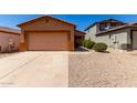 Inviting single-story home with a well-maintained front yard and two-car garage, perfect for a Gathering at 1384 E Press Rd, San Tan Valley, AZ 85140