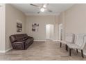 Bright living room features wood-look floors, neutral paint, comfortable seating, and an arched doorway at 3509 E Hazeltine Way, Chandler, AZ 85249