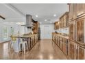 Spacious kitchen with wooden cabinets, granite countertops, stainless steel appliances, and hardwood floors at 6747 N 12Th St, Phoenix, AZ 85014