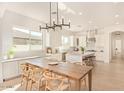 Bright, spacious kitchen with stainless appliances, central island, and adjacent dining area at 19162 E Mockingbird Dr, Queen Creek, AZ 85142