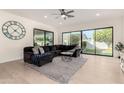 Bright living room with large sliding glass doors, a comfortable sectional sofa, and a modern coffee table at 19162 E Mockingbird Dr, Queen Creek, AZ 85142