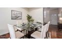 Dining room with a modern glass table, seating for six, and stylish decor at 2315 W Union Hills Dr # 120, Phoenix, AZ 85027