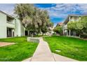 Lush green lawns with mature shade trees and walking paths at 2315 W Union Hills Dr # 120, Phoenix, AZ 85027