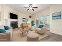 Bright living room featuring a fireplace, ceiling fan, and access to a small outdoor patio at 2315 W Union Hills Dr # 120, Phoenix, AZ 85027