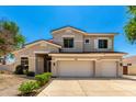 Traditional two-story home boasts a three-car garage and well-maintained lawn at 5752 S Crossbow Pl, Chandler, AZ 85249