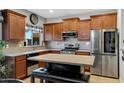 Well-equipped kitchen with stainless steel appliances, center island, and ample cabinet space at 88 W Reeves Ave, San Tan Valley, AZ 85140